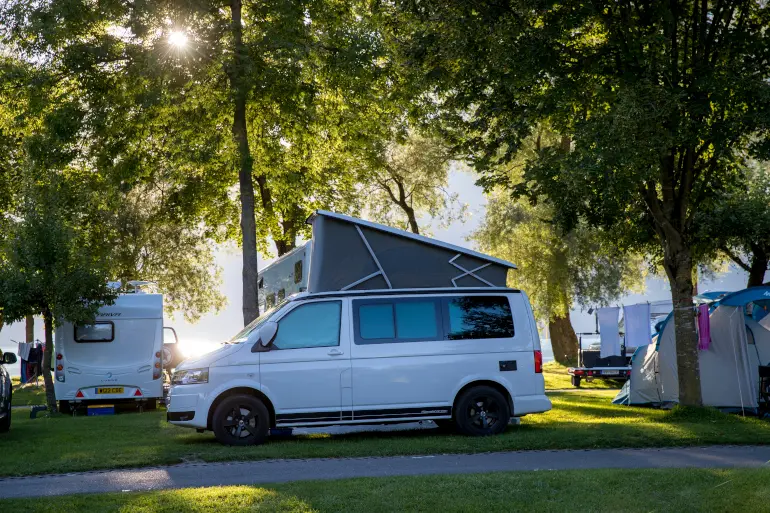 Schattige Parzellen für Reisemobile, Wohnwagen oder Zelte auf dem Camping Aaregg am Brienzersee, Schweiz